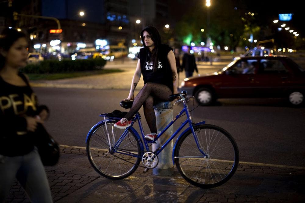 In this Nov. 28, 2012 photo, Nadia Estanguet sits with her bicycle in Buenos Aires, Argentina. Civic leaders have tried to make Buenos Aires a bicycle-friendly city, but that's been stymied by protectionist import bans designed to spur domestic production. (Natacha Pisarenko/AP)