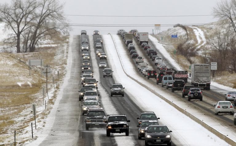 Traffic winds its way east and west along a snowy Boulder-Denver Turnpike, in Superior, Colo. on Wednesday. (Brennan Linsley/AP)