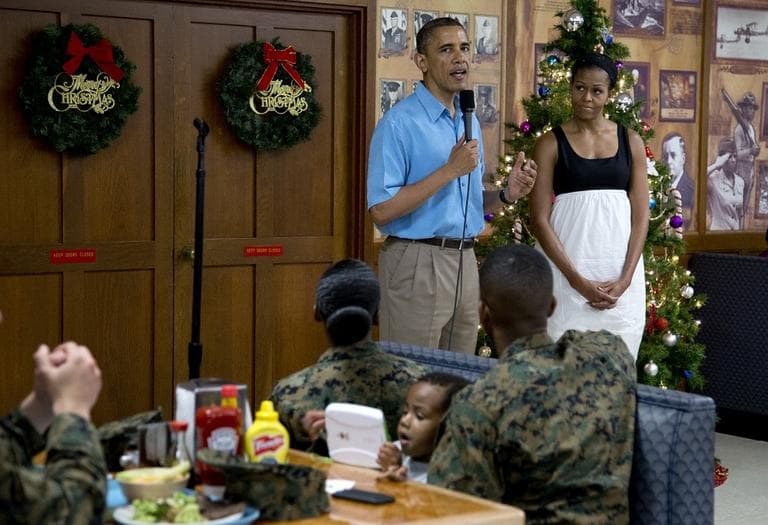 President Barack Obama speaks as first lady Michelle Obama listens during a visit with members of the military and their families in Anderson Hall at Marine Corp Base Hawaii, Tuesday, Dec. 25, 2012, in Kaneohe Bay, Hawaii. (Carolyn Kaster/AP)