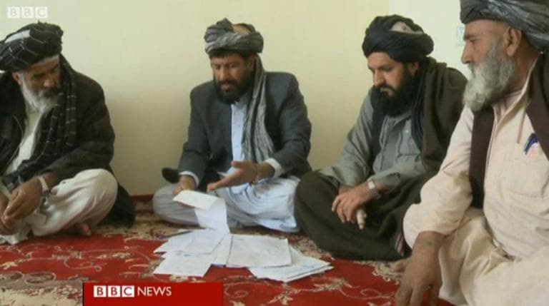 In Helmand, committees of village elders rule on small disputes between neighbors. The elders say what they're offering is more progressive than the old-style tribal law, where daughters were often handed over to settle disputes. It's cheap, quick, popular and in direct competition with the local justice that's been provided by the Taliban. (BBC screenshot)