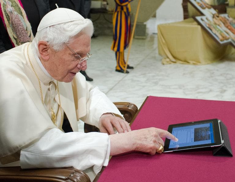 In this photo provided by the Vatican newspaper L'Osservatore Romano, Pope Benedict XVI pushes a button on a tablet at the Vatican.  (Osservatore Romano/AP)