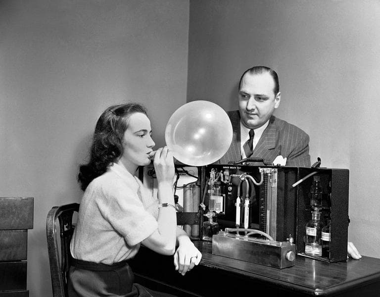 Dorothy Brengel helps W.D. Foden, Chairman of Statler Safety Committee, demonstrate the “Drunkometer”, a breath tests for alcohol, on display at the Greater New York Safety Council, Hotel Statler, March 28, 1950. For the preliminary test, the breath of the suspect is collected in a balloon and passed through a purple fluid (potassium permanganate and sulphuric acid) to see if it changes color. The breath of a non-drinking person will cause no change. If the purple color disappears, the amount of breath required to accomplish this indicates the approximate accumulation of alcohol in the blood. (AP/Carl Nesensohn)