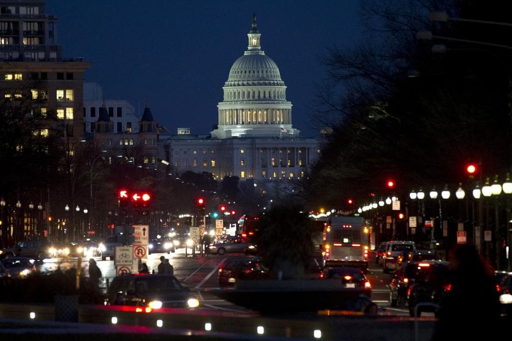 Red lights illuminate Pennsylvania Avenue as the U.S. Capitol glows in the twilight, in Washington, Wednesday, Dec. 19, 2012, as talks continue on the looming fiscal cliff. (AP)
