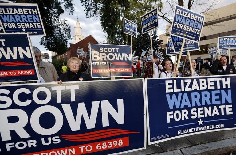 Supporters of Republican incumbent Sen. Scott Brown and Democratic challenger Elizabeth Warren hold signs outside Symphony Hall in Springfield, Mass. on Oct. 10 prior to their third debate. (Elise Amendola/AP)