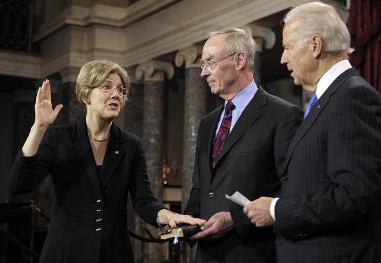 Vice President Joe Biden administers the oath of office to Sen. Elizabeth Warren, who's accompanied by her husband, Bruce Mann, during a mock swearing in ceremony on Capitol Hill Thursday. (Cliff Owen/AP)