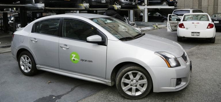 Avis is buying Zipcar for $491.2 million, expanding its offerings from traditional car rentals to car sharing services. Pictured here is a a Zipcar is parked at a lot in New York on Wednesday, Jan. 2, 2013. (Mark Lennihan/AP)