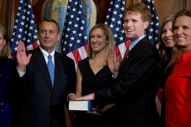 House Speaker John Boehner performs a mock swearing in for new Rep. Joseph Kennedy Thursday on Capitol Hill. (Evan Vucci/AP)