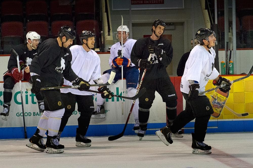 Boston Bruins including, Milan Lucic (second from left), Andrew Ference, Adam McQuaid (second from right) and Brad Marchand take part in an unofficial practice session at Boston University Monday. (Jesse Costa/WBUR)