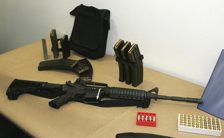 This March 27, 2006 file photo, shows a Bushmaster AR-15 semi-automatic rifle and ammunition on display at the Seattle Police headquarters in Seattle. A similar rifle was used in the Newtown school massacre. (Ted S. Warren/AP)