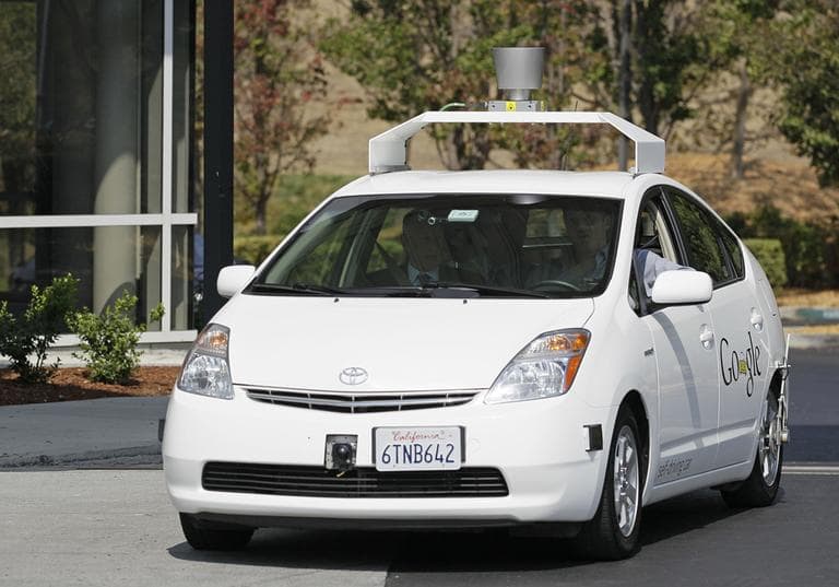 California Gov. Edmund G Brown Jr., front left, rides in a driverless car  to a bill signing at Google headquarters in Mountain View, Calif., in September 2012. (Eric Risberg/AP)