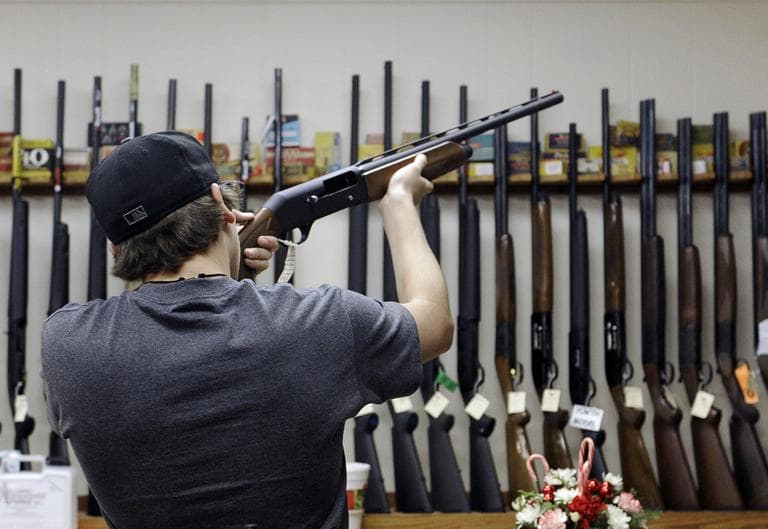 In this Wednesday, Dec. 19, 2012 file photo, a customer checks out a shotgun at Burdett &amp; Son Outdoor Adventure Shop in College Station, Texas. (Pat Sullivan/AP)