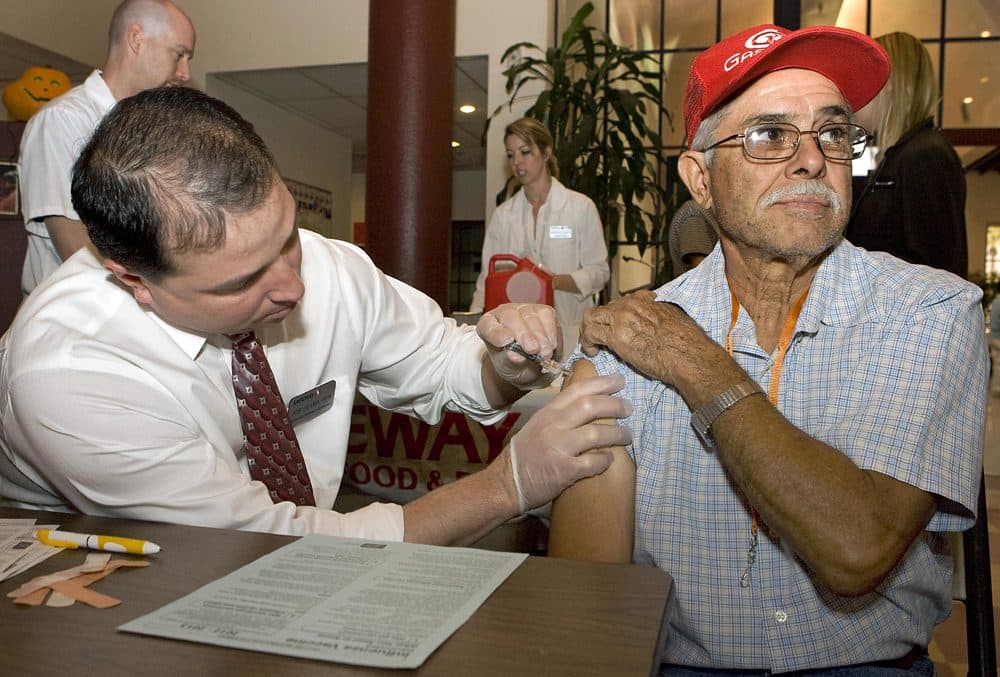 The flu season has not abated, even though it is spring. Pictured, Jesus Ortiz gets a flu shot in this 2012 photo. (John Miller/AP/NCOA)