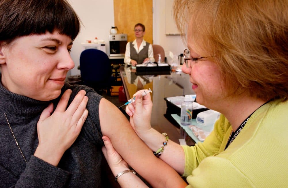 In the U.S., the flu season can range from November through March, and even past March in some years. Here, a CDC employee receives a flu vaccine from CDC staff nurse. (James Gathany/CDC)