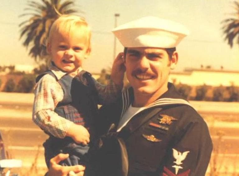 Rob Guzzo is pictured as a child, being held by his father, Bob Guzzo, also a Navy SEAL. (Screenshot from The Fold)