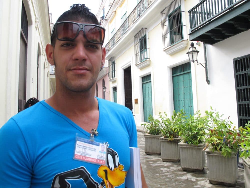 Street artist Danny Diaz has a license from the Cuban government that allows him to sell drawings to tourists. (Andrea Shea/WBUR)