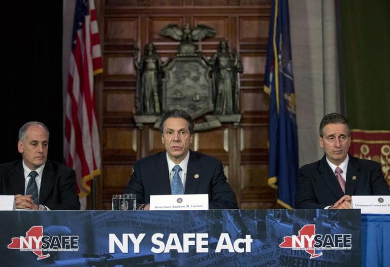 New York Gov. Andrew Cuomo, center, speaks on Monday during a news conference announcing an agreement with legislative leaders on New York's Secure Ammunition and Firearms Enforcement Act. Also pictured are Secretary to the Governor Larry Schwartz, left, and Lt. Gov. Robert Duffy. (Mike Groll/AP)