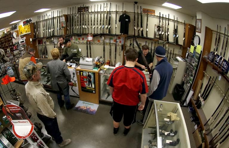 In this photo made with a fisheye lens, customers line up at the gun counter at Duke's Sport Shop on Tuesday in New Castle, Pa. (Keith Srakocic/AP)