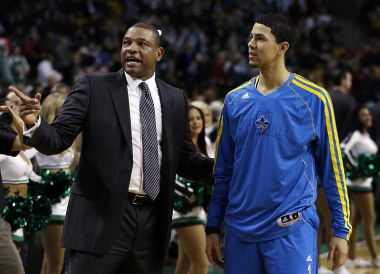 Boston Celtics head coach Doc Rivers talks with his son, New Orleans Hornets shooting guard Austin Rivers, prior to a game in Boston Wednesday. (Elise Amendola/AP)