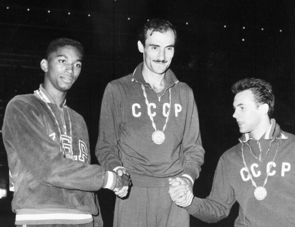 John Thomas (left) after winning the bronze at the 1960 Olympics.  Thomas died on Tuesday. (AP)