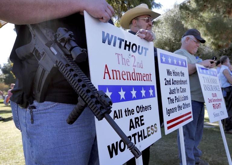 Gun rights supporters stand outside the Capitol Sat, Jan. 19, 2013 in Phoenix during a Guns Across America rally. (Matt York/AP)