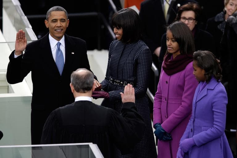President Barack Obama receives the oath of office from Chief Justice John Roberts as first lady Michelle Obama (L-R) and his daughters Malia and Sasha listen at the ceremonial swearing-in at the U.S. Capitol during the 57th Presidential Inauguration in Washington, Monday, Jan. 21, 2013. (Evan Vucci/AP)