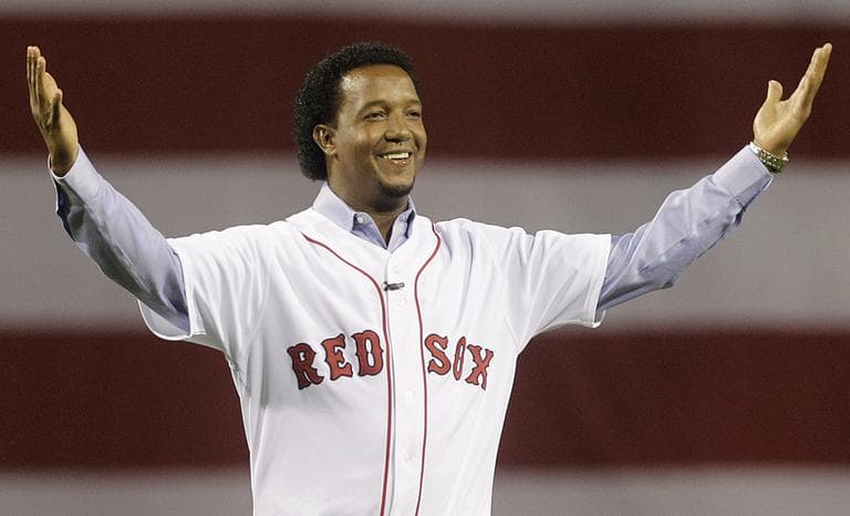 Former Red Sox pitcher Pedro Martinez greets the crowd before throwing the ceremonial first pitch before the opening game of the 2010 season. (Elise Amendola/AP)