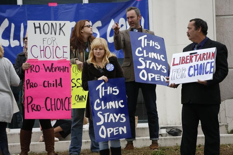 Women's rights and pro-abortion rights supporters stand outside the Jackson Women's Health Organization on Tuesday. (Rogelio V. Solis/AP)