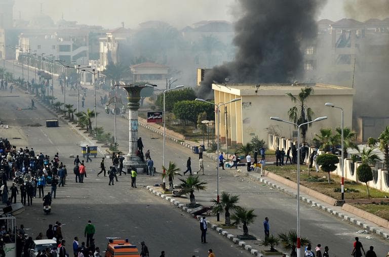 Egyptian protesters clash with police, unseen, in Port Said, Egypt, Sunday, Jan. 27, 2013. Violence erupted briefly when some in the crowd fired guns and police responded with volleys of tear gas, witnesses said. (AP)