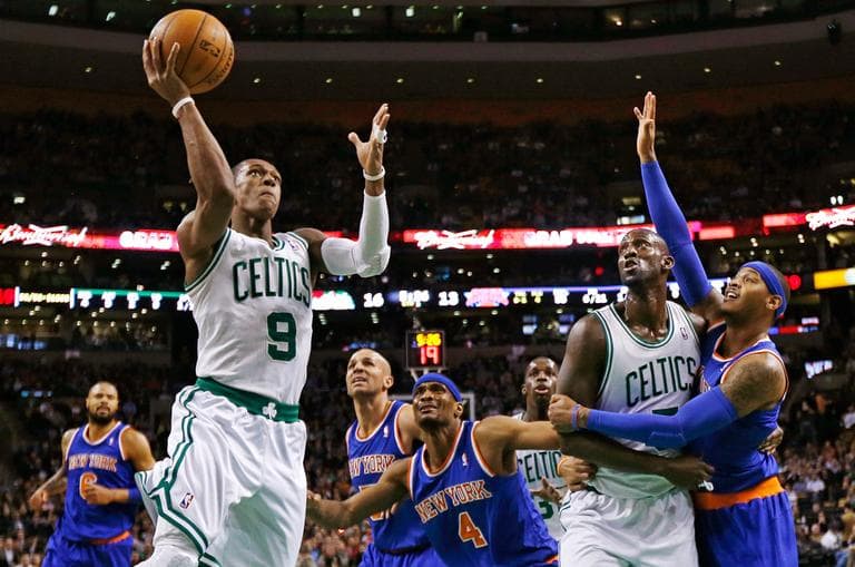 Boston Celtics guard Rajon Rondo (9) drives to the basket as Kevin Garnett blocks out New York Knicks forward Carmelo Anthony, right, during the first quarter of an NBA basketball game in Boston, Thursday, Jan. 24, 2013. (Charles Krupa/AP)