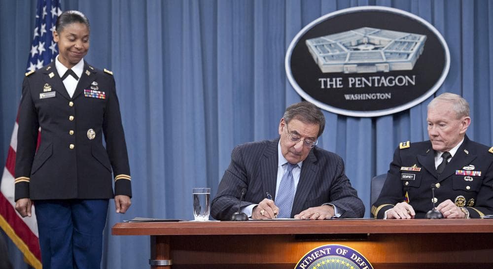 Defense Secretary Leon Panetta, flanked by Joint Chiefs Chairman Gen. Martin Dempsey, right, and Army Lt. Col. Tamatha Patterson, signs a memorandum ending the 1994 ban on women serving in combat roles in the military, Thursday, Jan. 24, 2013. (Cliff Owen/AP) 