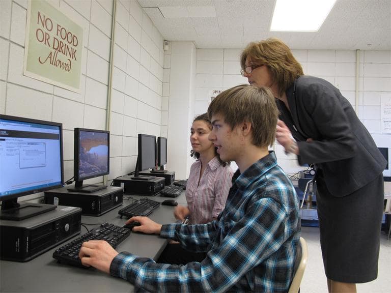 Jonathan Flatley and Joclyn Crivello are taking an AP physics course online. Milford High School Vice Principal Carolyn Banach offers support. (Monica Brady-Myerov/WBUR)