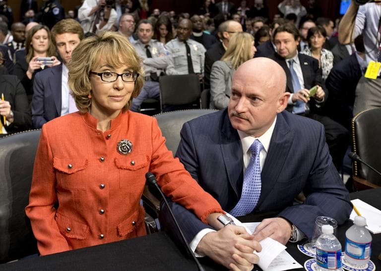 Former Arizona Rep. Gabrielle Giffords, who was seriously injured in the mass shooting that killed six people in Tucson, Ariz. two years ago, sits with her husband, Mark Kelly, right, a retired astronaut,  on Wednesday, prior to speaking before the Senate Judiciary Committee hearing on what lawmakers should do to curb gun violence in the wake of last month's shooting rampage in Newtown, Conn. (J. Scott Applewhite/AP)
