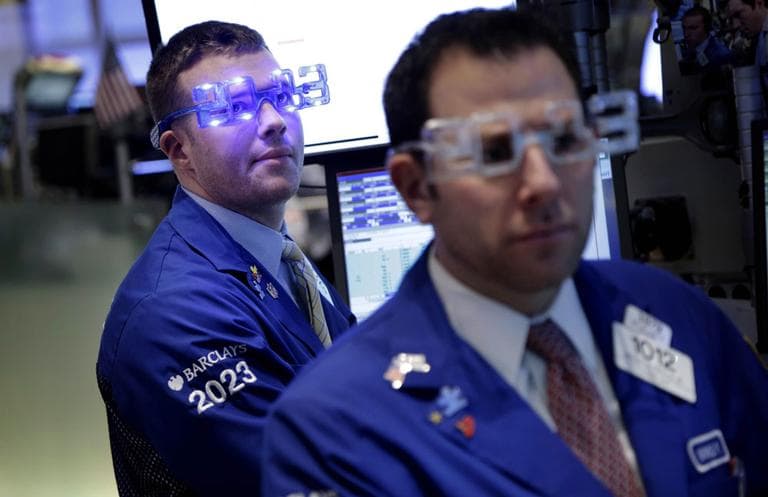 Traders wear &quot;2013&quot; glasses as they work on the floor at the New York Stock Exchange in New York. (AP)