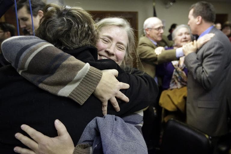 C. Kelly Smith, of Providence, R.I., center, a member of Marriage Equality Rhode Island, hugs fellow member Wendy Becker, left, also of Providence, after a house committee vote on gay marriage at the Statehouse, in Providence, Tuesday, Jan. 22, 2013. (AP)