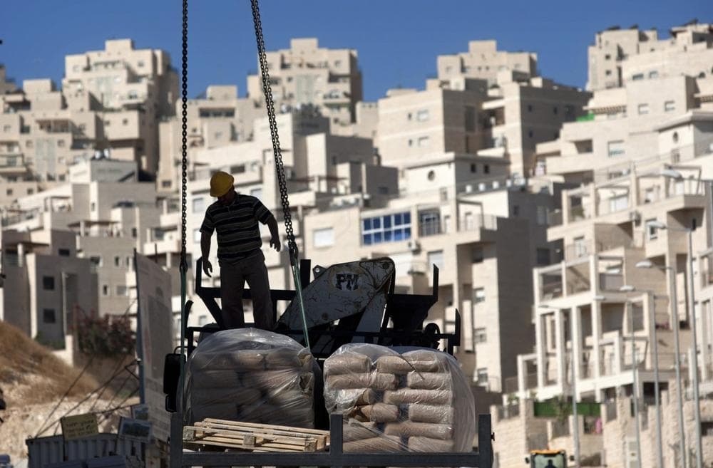 In this Nov. 2, 2011 file photo, a construction worker works on a new housing unit in the east Jerusalem neighborhood of Har Homa. (AP)