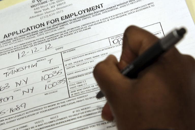 Taneshia Wright, of Manhattan, fills out a job application during a job fair in New York in December 2012. (Mary Altaffer/AP)