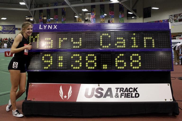 Mary Cain poses next to the board after setting a girls high school record in the two-mile race at the Boston Indoor Grand Prix, Saturday, Feb. 2, 2013, in Boston. Cain finished third overall. (Mary Schwalm/AP)