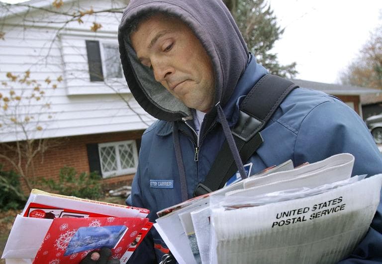File photo of U.S. Letter Carrier Gerald Tannehill delivering mail in Springfield, Ill. (AP/Seth Perlman)