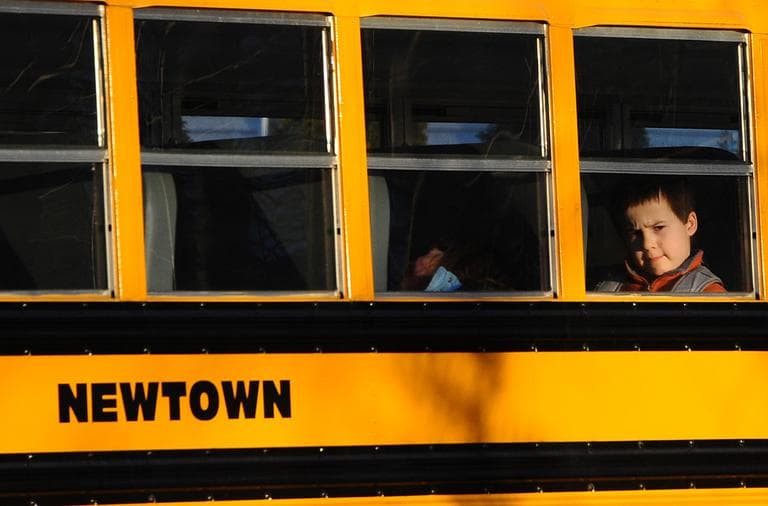 A boy sits on a Newtown bus leaving the new Sandy Hook Elementary School after the first day of classes in Monroe, Conn., Thursday, Jan. 3, 2013.  The former Chalk Hill School was renamed Sandy Hook Elementary and overhauled especially for the students from the Sandy Hook School shooting. (Jessica Hill/AP)