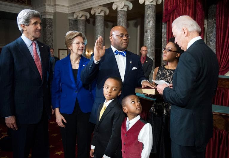 Vice President Joe Biden re-enacts administering the Senate oath to Sen. William &quot;Mo&quot; Cowan Thursday on Capitol Hill. Joining him, from left: Secretary of State John Kerry, Sen. Elizabeth Warren, his sons Miles, 8, and Grant 4, and his wife Stacey. (Kevin Wolf/AP)