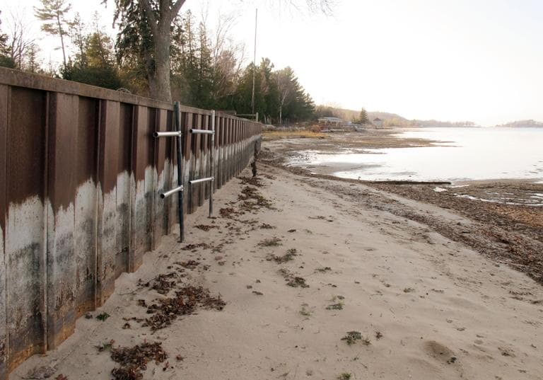 In this Nov. 16, 2012 photo, the white streaks on a steel breakwall show the normal water level on Portage Lake at Onekama, Mich., which is connected by a channel to Lake Michigan. Levels across much of the Great Lakes are abnormally low, causing problems for small harbor towns that rely on boating and water tourism. (John Flesher/AP)