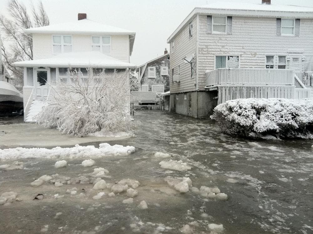 Water and ice flood streets in Scituate on Saturday. (David Boeri/WBUR)