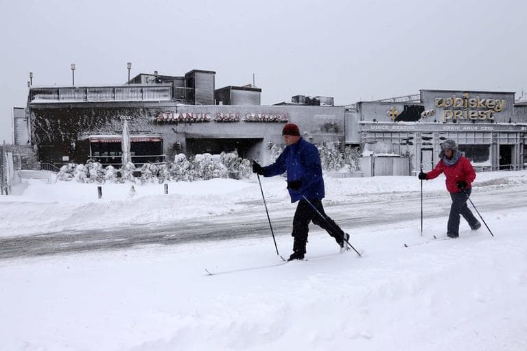 Brendan and Lisa Koeniger of Boston, cross country ski through Boston's Seaport area on Saturday. (Gene J. Puskar/AP)