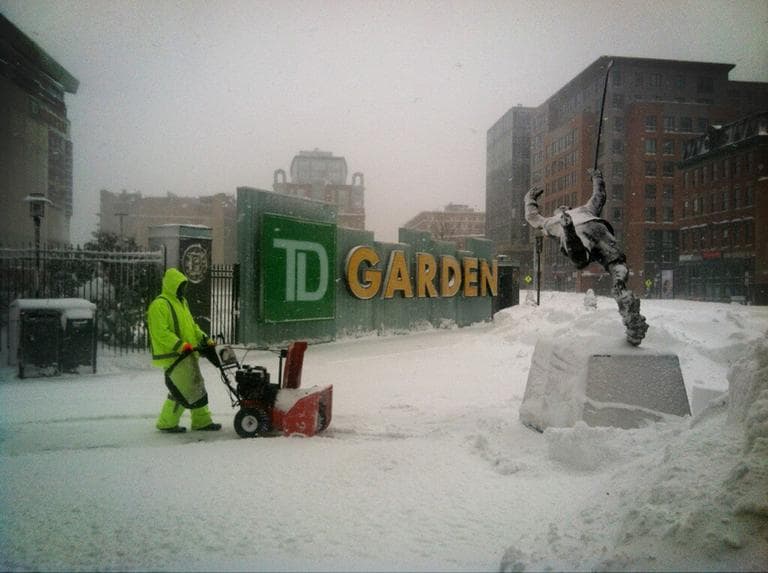 The outside of TD Garden is being plowed Saturday morning. The Bruins game is still scheduled for Saturday night, but one worker told WBUR's Curt Nickisch that the game should be cancelled since there's no MBTA service. (Curt Nickisch/WBUR)