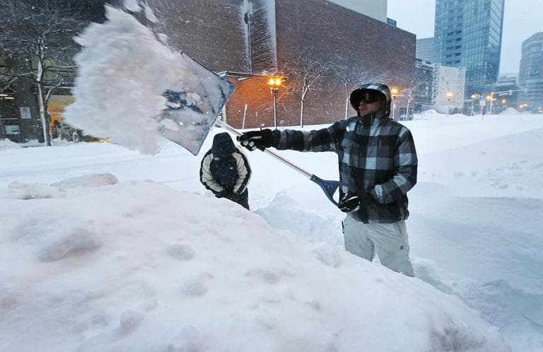 Andrew Laliberte digs a pathway through a high snow drift in Boston on Saturday. (Charles Krupa/AP)