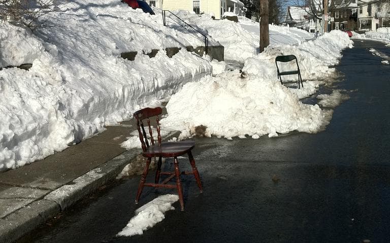 Chairs claim cleared out parking spaces on Brown Ave. in Hyde Park on Sunday. (Delores Handy/WBUR)
