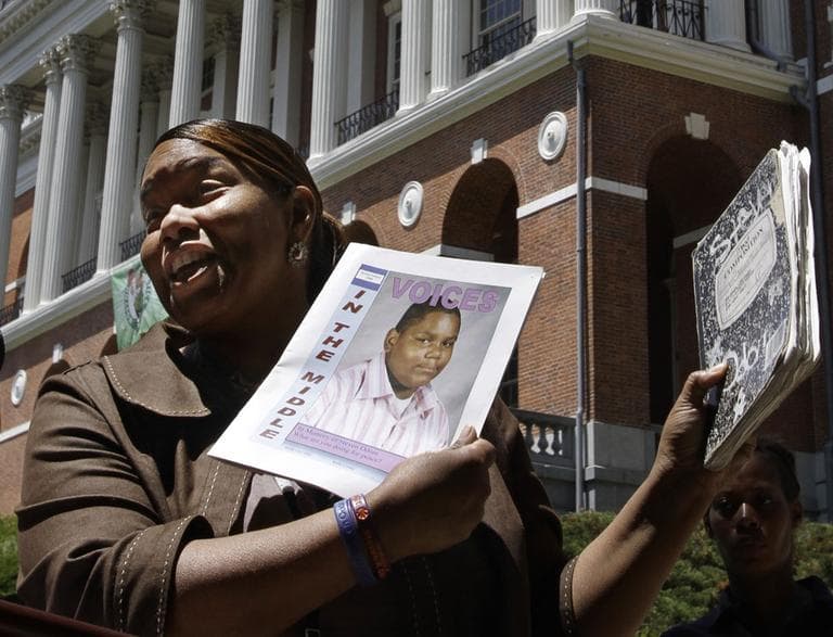 In this 2010 photo, Kim Odom, mother of 13-year-old shooting victim Steven Odom, displays a photo of her slain son during a rally in front of the State House in Boston. Odom will attend the State of the Union address. (Steven Senne/AP)