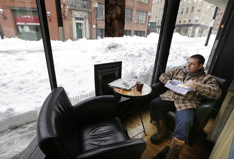 Matt Church enjoys his breakfast at a coffee shop in downtown Haverhill, Mass., Monday, Feb. 11, 2013. Beleaguered Massachusetts residents returned to work on Monday for the first time since the weekend blizzard, crawling along narrow snow-covered secondary roads and being greeted by a new wintry mix of sleet and freezing rain. (Elise Amendola/AP)