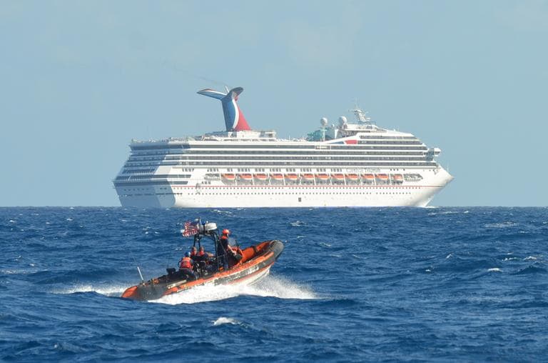 In this image released by the U.S. Coast Guard on Feb. 11, 2013, a small boat belonging to the Coast Guard Cutter Vigorous patrols near the cruise ship Carnival Triumph in the Gulf of Mexico, Feb. 11, 2013. (Lt. Cmdr. Paul McConnell/U.S. Coast Guard)