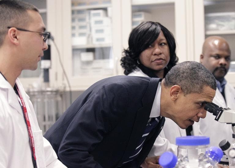 President Barack Obama looks through a microscope during his tour the Bio-technology program at Forsyth Tech Community College in Winston-Salem, N.C., in 2010. (Pablo Martinez Monsivais/AP)